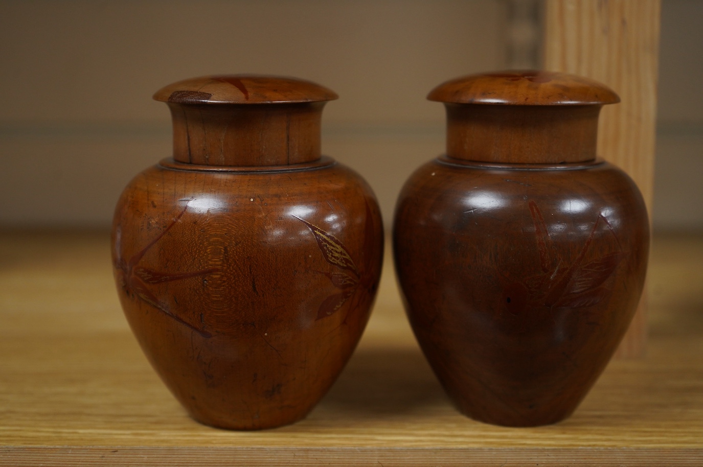 A pair of 18th century lacquered pear wood tea caddies, as seen in Pinto's book, page 293 and plate 315 (D), 12.5cm tall. Condition - repairs to covers, some wear to lacquer